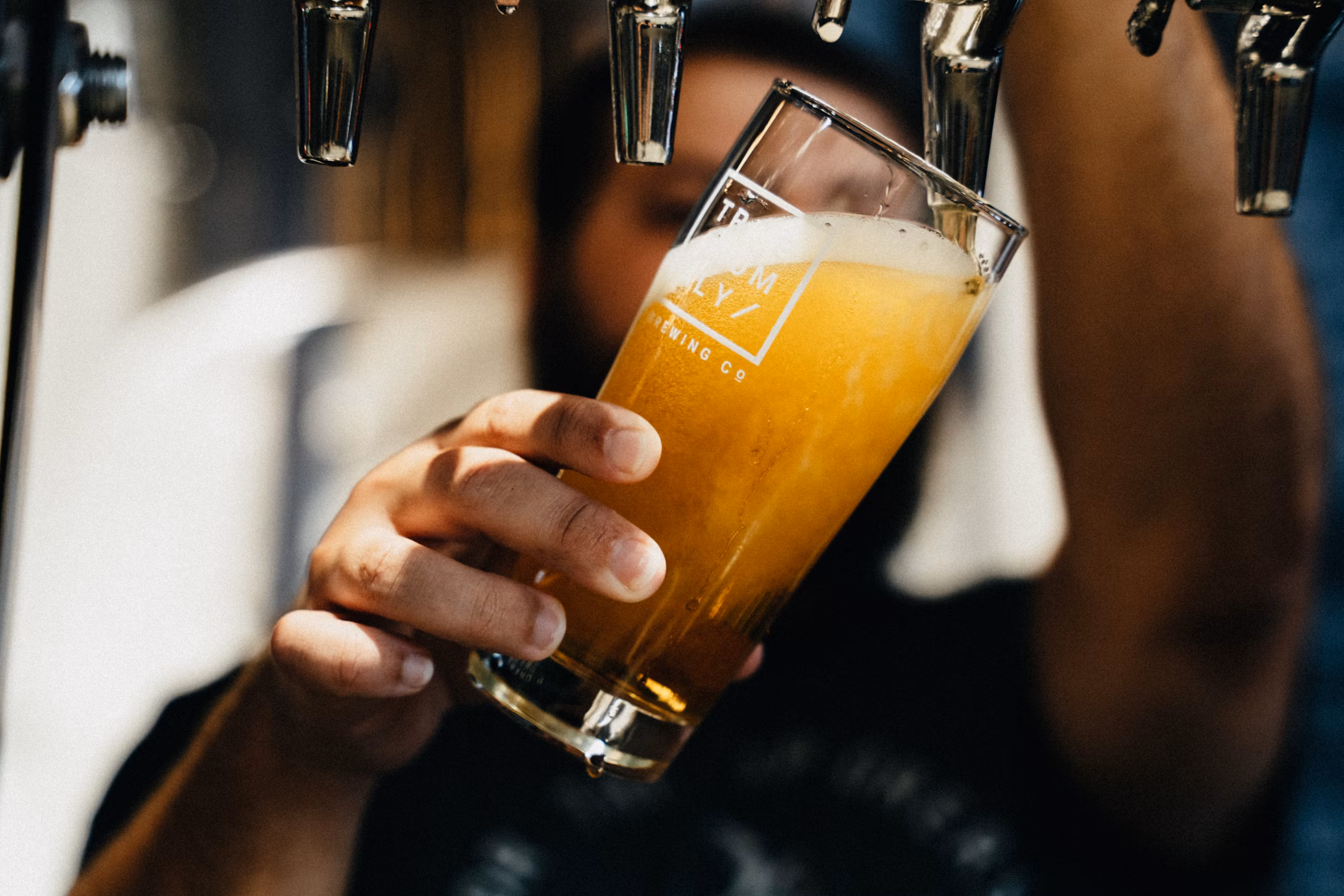 Pessoa servindo um chopp - Foto: Unsplash